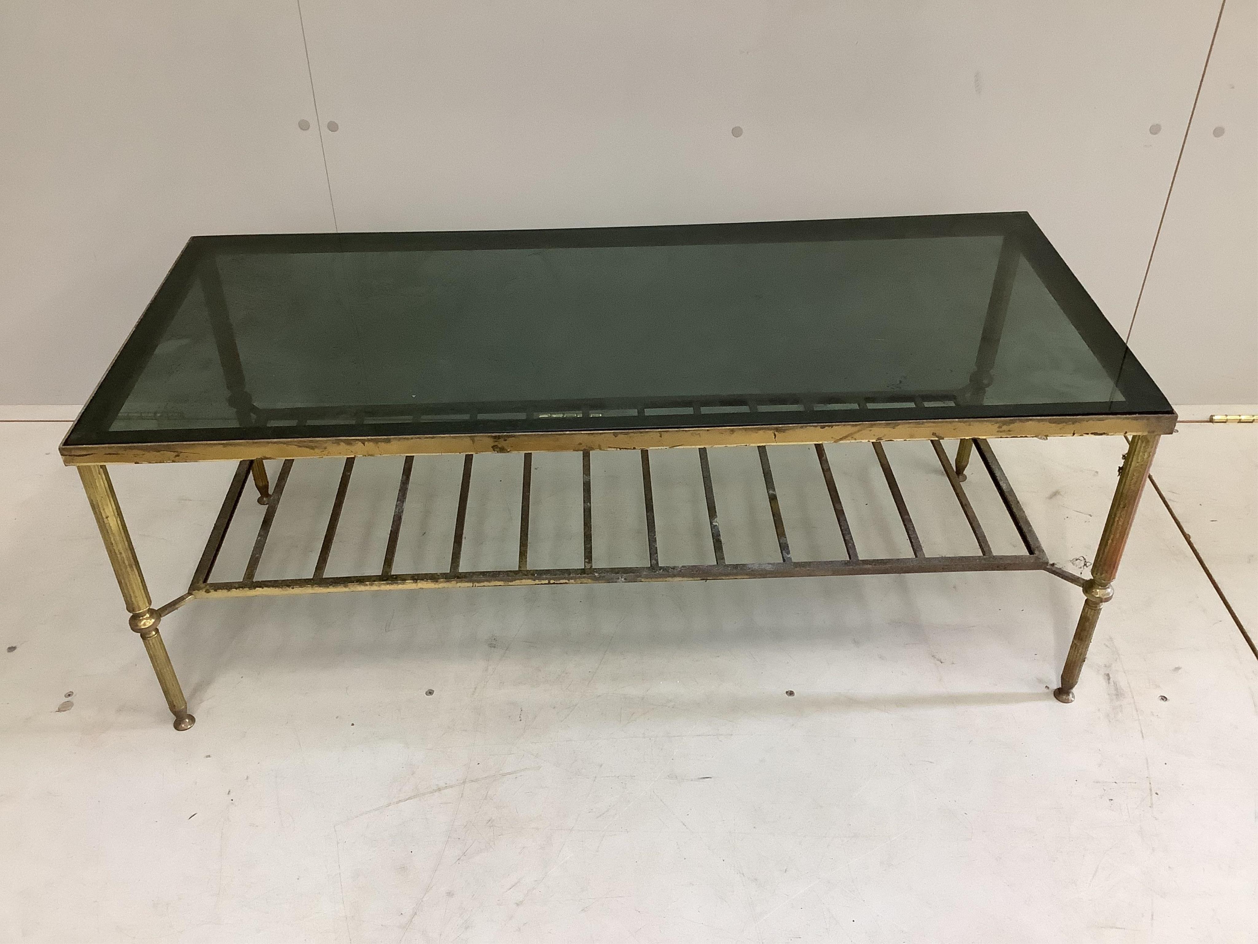 A Maison Jansen style two tier rectangular brass framed coffee table with smoke glass top, width 107cm, depth 46cm, height 41cm